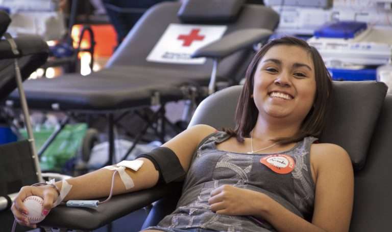 August 29, 2012. Utah State University, Logan, Utah. 18-year-old Amanda Guzman is all smiles knowing that her donation makes a difference. Photo by Jody Lane/American Red Cross